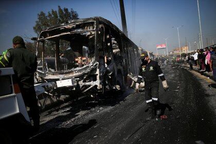 Un autobús de Transmilenio quemado es remolcado después de fuertes protestas contra la brutalidad policial en Bogotá