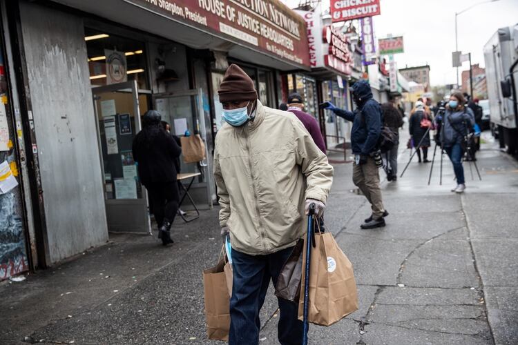 Un hombre con una máscara protectora tras recibir comidas gratis durante el brote de coronavirus en la ciudad de Nueva York, EE.UU., el 18 de abril de 2020. (REUTERS/Jeenah Moon)