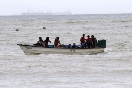 Migrantes venezolanos recientemente deportados llegan a la costa en la playa Los Iros, en Erin, Trinidad y Tobago (Lincoln Holder/Courtesy Newsday/via REUTERS)