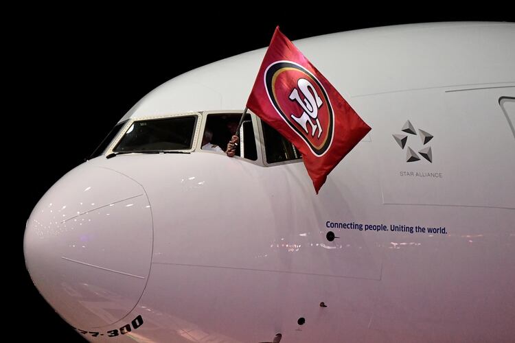 Jan 26, 2020; Miami, Florida, USA; The pilot waives a San Francisco 49ers flag as the San Francisco 49ers arrive at Miami International airport to play the Kansas City Chiefs in Super Bowl LIV. Mandatory Credit: Jasen Vinlove-USA TODAY Sports
