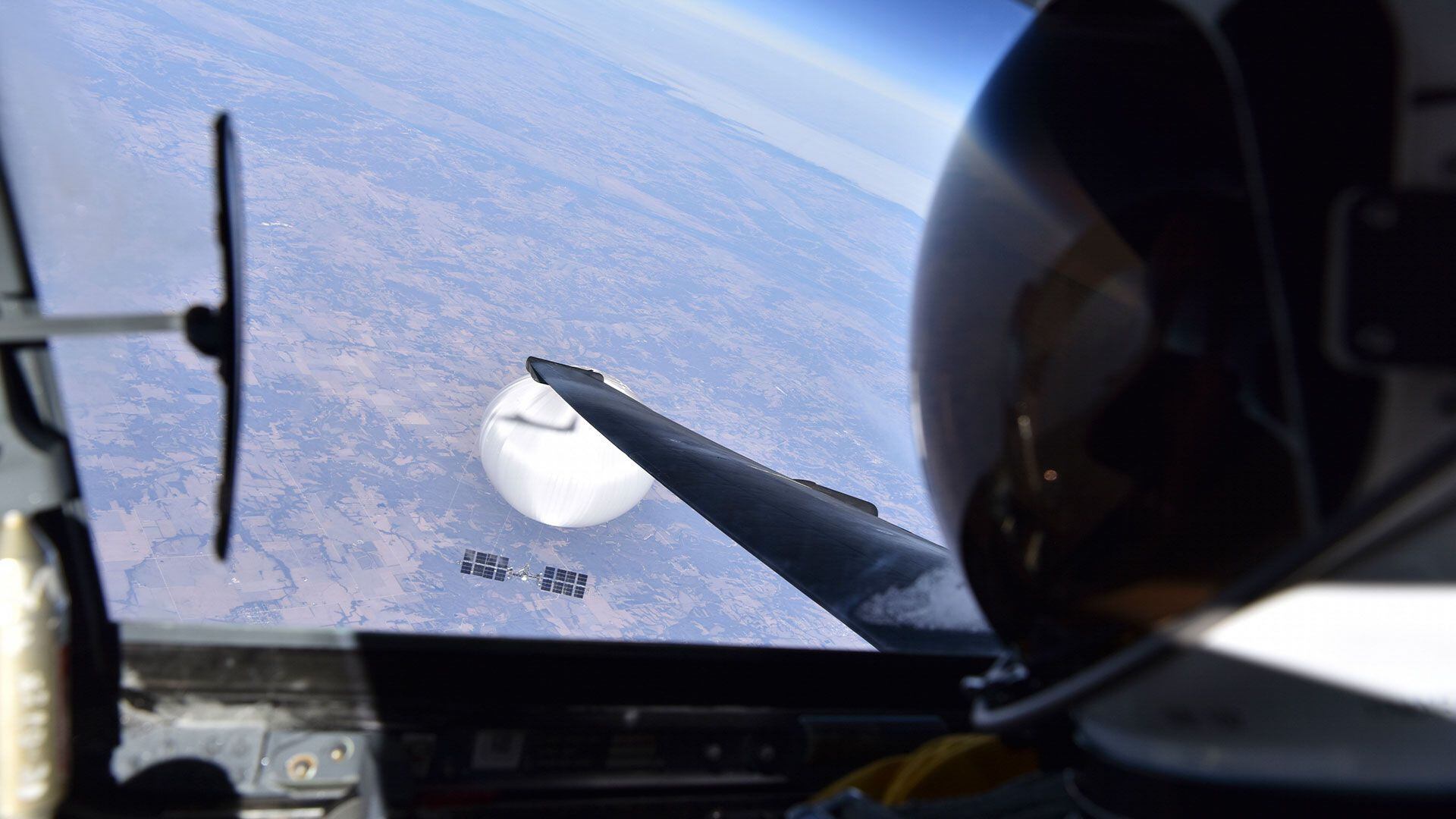 In this image released by the Department of Defense on Wednesday, Feb. 22, 2023, a U.S. Air Force U-2 pilot looks down at a suspected Chinese surveillance balloon as it hovers over the United States on Feb. 3, 2023. (Department of Defense via AP)