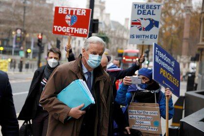 EU chief negotiator Michel Barnier walks near protesters while heading to 1VS conference centre for Brexit talks in London, Britain, December 2, 2020. REUTERS/John Sibley