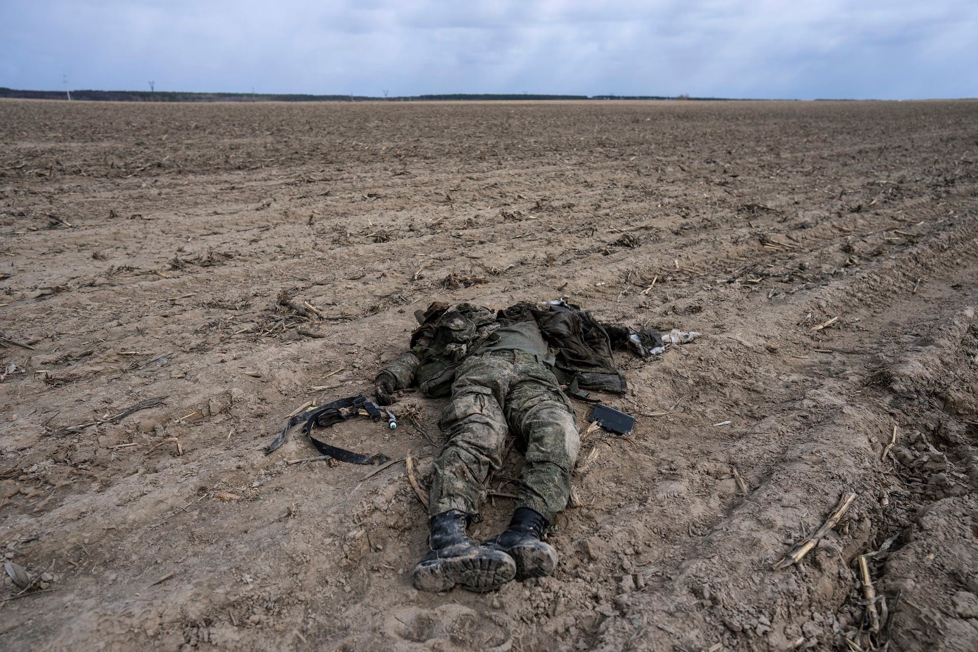 A Russian soldier killed during combats against Ukrainian army lies on a corn field in Sytnyaky, on the outskirts of Kyiv, Ukraine, Sunday, March 27, 2022. Ukrainian President Volodymyr Zelenskyy accused the West of lacking courage as his country fights to stave off Russia's invading troops, making an exasperated plea for fighter jets and tanks to sustain a defense in a conflict that has ground into a war of attrition. (AP Photo/Rodrigo Abd)