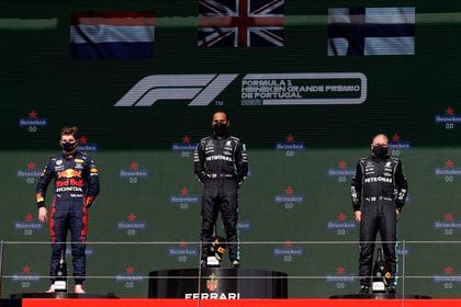 Formula One F1 - Portuguese Grand Prix - Algarve International Circuit - Portimao, Portugal - May 2, 2021 Mercedes' Lewis Hamilton on the podium after winning the race alongside second place Red Bull's Max Verstappen and third place Mercedes' Valtteri Bottas REUTERS/Juan Medina