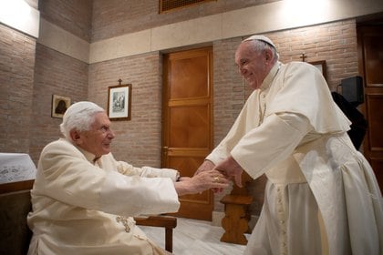 El Papa Francisco saluda al Papa Emérito Benedicto XVI durante una reunión después de una ceremonia del consistorio para instalar 13 nuevos cardenales, en el Vaticano, el 28 de noviembre de 2020 (Medios del Vaticano / vía REUTERS)