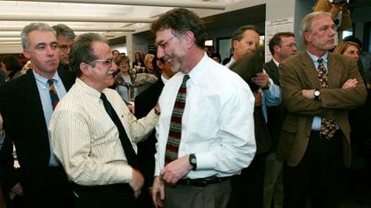 In an April 7, 2003 photo, Boston Globe editor Martin Barron congratulated journalist Stephen Corjean after the newspaper won a Pulitzer Prize (AP Photo / Charles Krupa / Archive)