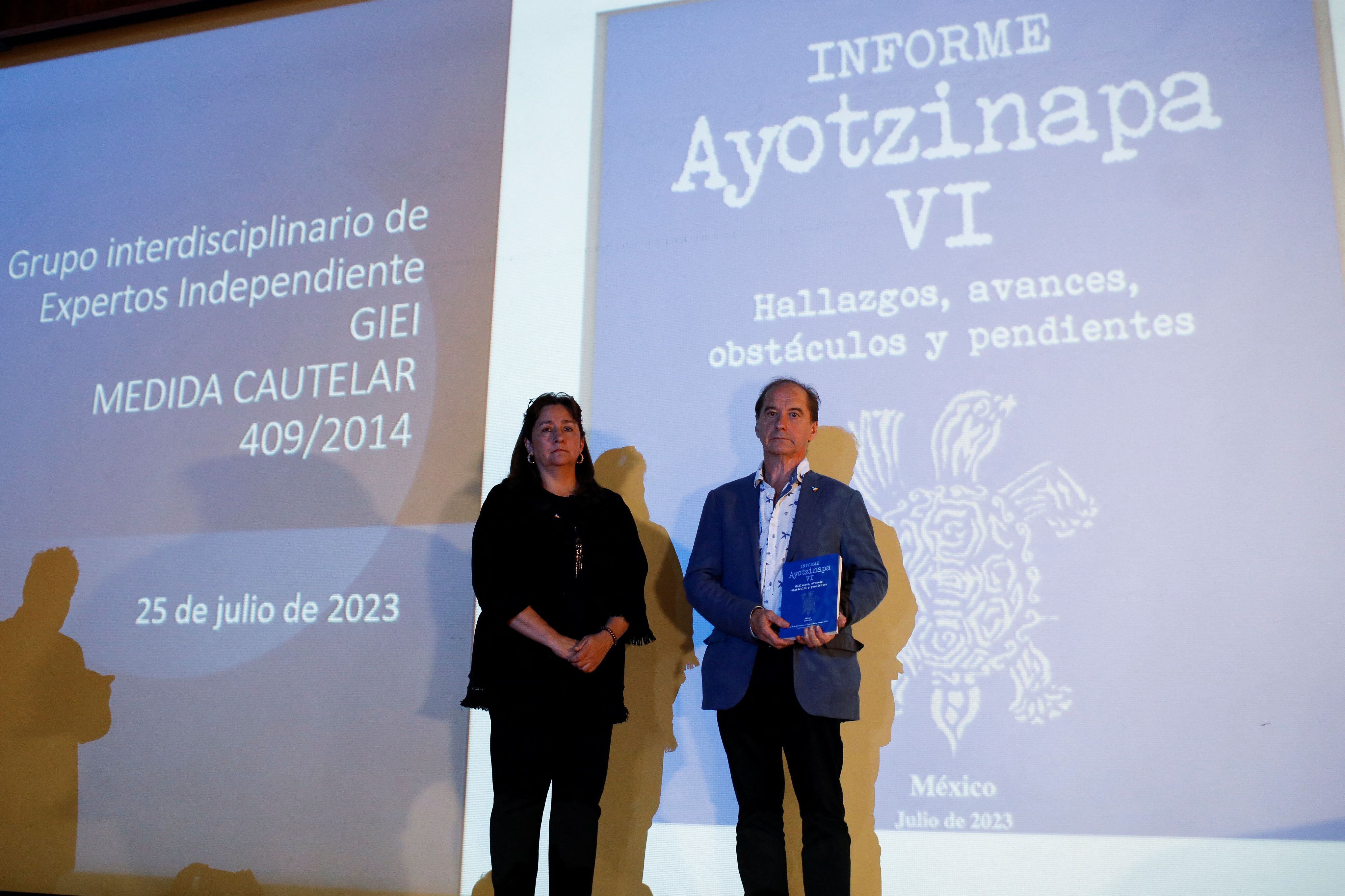 Carlos Martin Beristain and Angela Buitrago, members of the Interdisciplinary Group of Independent Experts (GIEI), pose with Ayotzinapa Report VI during the last press conference on the 43 missing students of the Ayotzinapa Teacher Training College, in Mexico City, Mexico July 25, 2023. REUTERS/Raquel Cunha