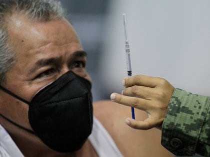 A soldier shows an injection with a dose of China's CanSino COVID-19 vaccine to a man during a mass vaccination against coronavirus disease at the Autonomous University of Nuevo Leon in San Nicolas de los Garza, on the outskirts of Monterrey, Mexico April 27, 2021. REUTERS/Daniel Becerril
