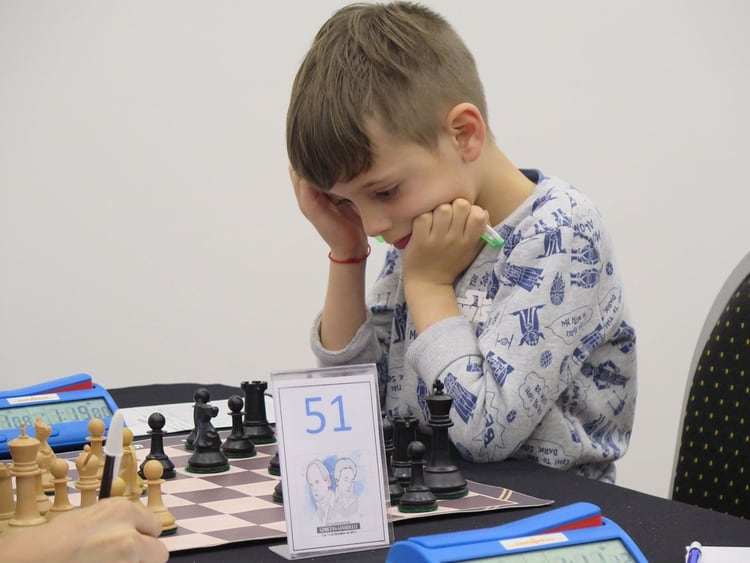 La concentración de Ilan en medio de una partida. El padre no quiere que juegue mucho ajedrez blitz (partidas a 3 minutos por jugador), para que no adquiera un hábito impulsivo en lugar de la reflexión