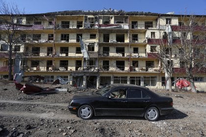 A man drives a car past a damaged building following recent shelling in the town of Shushi (Shusha), in the course of a military conflict over the breakaway region of Nagorno-Karabakh, October 29, 2020. Vahram Baghdasaryan/Photolure via REUTERS ATTENTION EDITORS - THIS IMAGE HAS BEEN SUPPLIED BY A THIRD PARTY.     TPX IMAGES OF THE DAY
