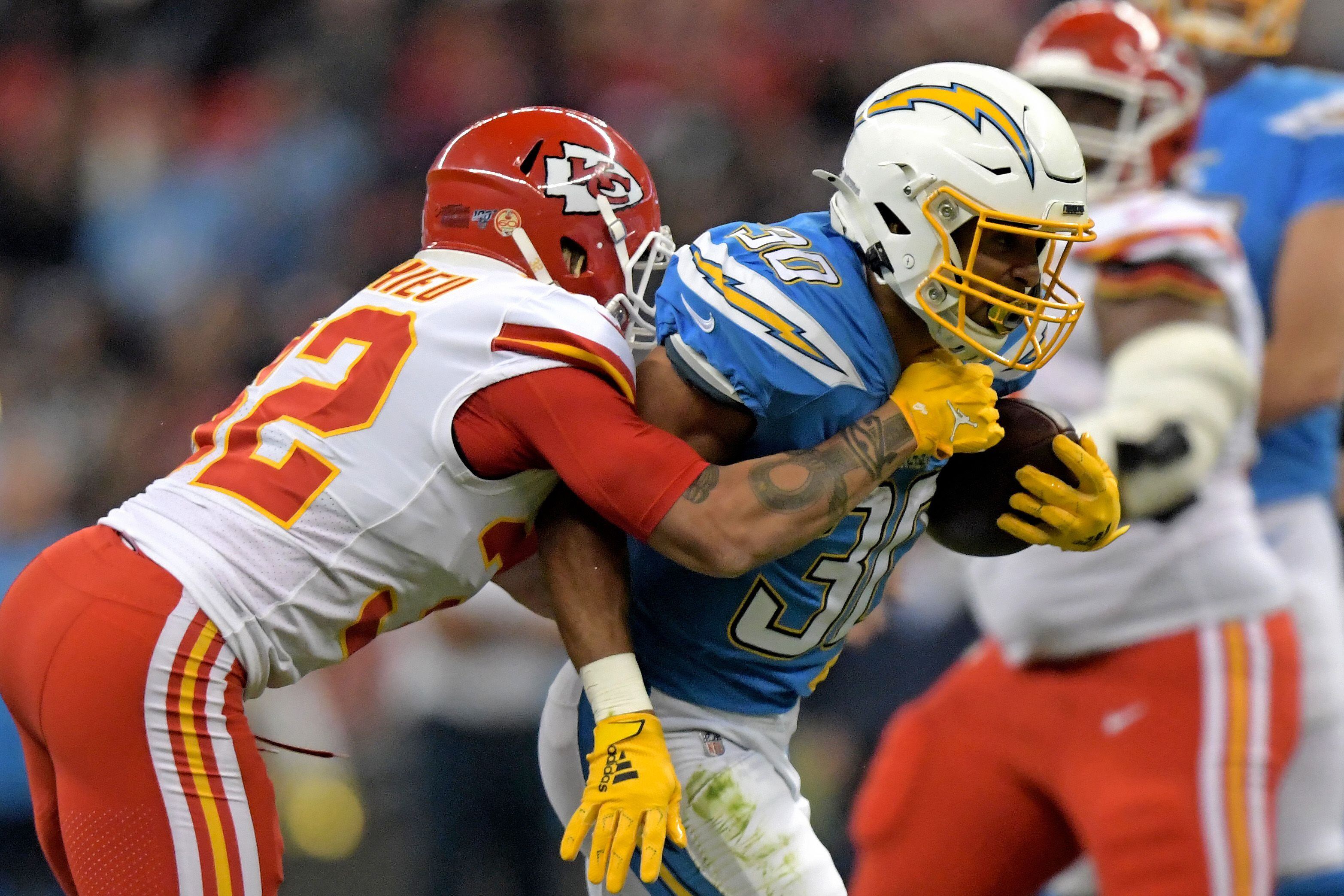 Nov 18, 2019; Mexico City, MEX; Los Angeles Chargers running back Austin Ekeler (30) is tackled by Kansas City Chiefs strong safety Tyrann Mathieu (32) in the first quarter during an NFL International Series game at Estadio Azteca. Mandatory Credit: Kirby Lee-USA TODAY Sports