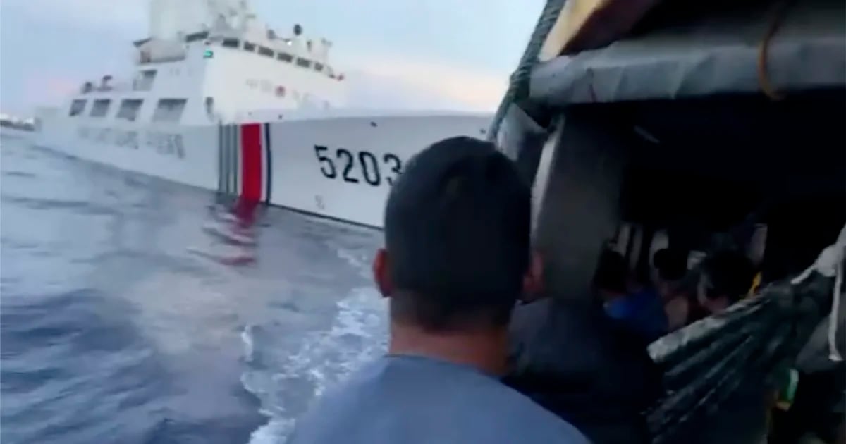 A Chinese coast guard collided with one of its cargo vessels in the South China Sea, the Philippines said.
