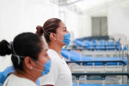 FILE PHOTO: Two nurses wearing protective masks pose inside the new immediate response mobile hospital with 50 intensive care beds against the outbreak of coronavirus disease (COVID-19) in Pachuca, Hidalgo, Mexico, March 19, 2020. Picture taken March 18, 2020. REUTERS/Henry Romero/File Photo