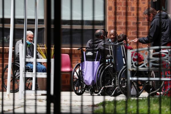 Residents sit inside of a small courtyard outside of the Hammonton Center for Rehabilitation and Healthcare one of numerous nursing homes to have staffing shortages during the national outbreak of the coronavirus disease (COVID-19) in Hammonton, New Jersey, U.S., May 19, 2020. Picture taken May 19, 2020. REUTERS/Lucas Jackson