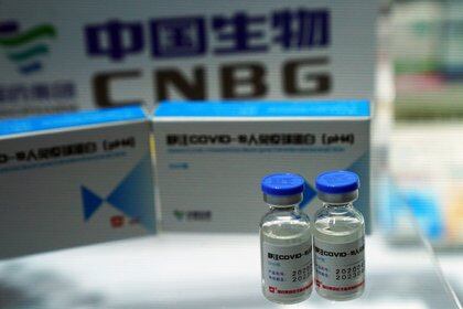 FILE PHOTO: A booth displaying a coronavirus vaccine candidate from China National Biotec Group (CNBG), a unit of state-owned pharmaceutical giant China National Pharmaceutical Group (Sinopharm), is seen at the 2020 China International Fair for Trade in Services (CIFTIS), following the COVID-19 outbreak, in Beijing, China September 4, 2020. REUTERS/Tingshu Wang/File Photo