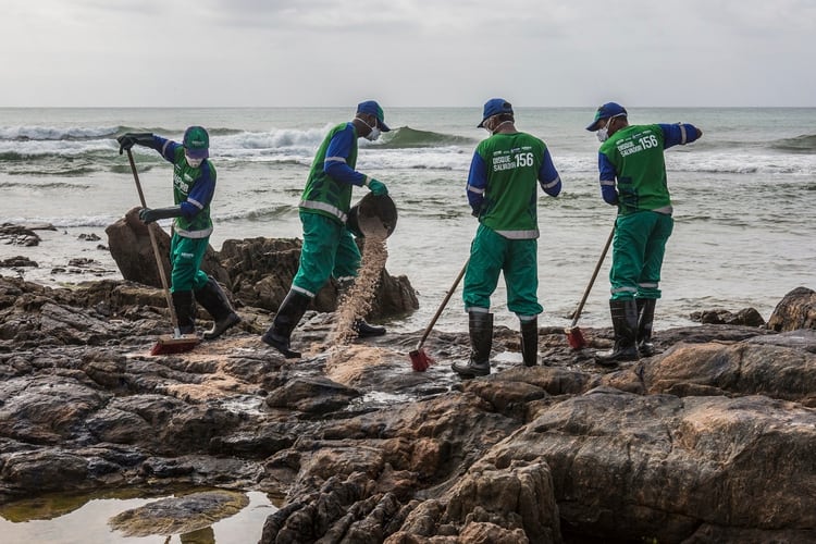 Trabajadores remueven petroleo en Salvador, Bahia (ANTONELLO VENERI / AFP)