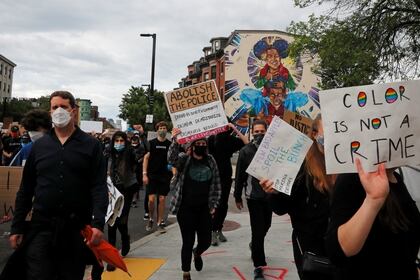 Una mujer sostiene un cartel con la leyenda "Ser de color no es un crimen", en Boston (REUTERS/Brian Snyder)