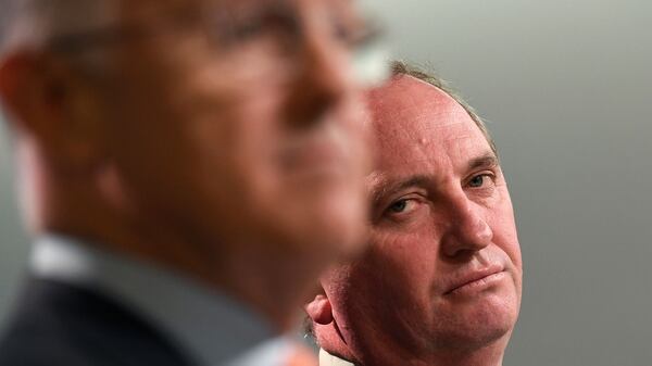El viceprimer ministro australiano, Barnaby Joyce, observa de atrás al premier, Malcolm Turnbull (AFP PHOTO / William WEST)