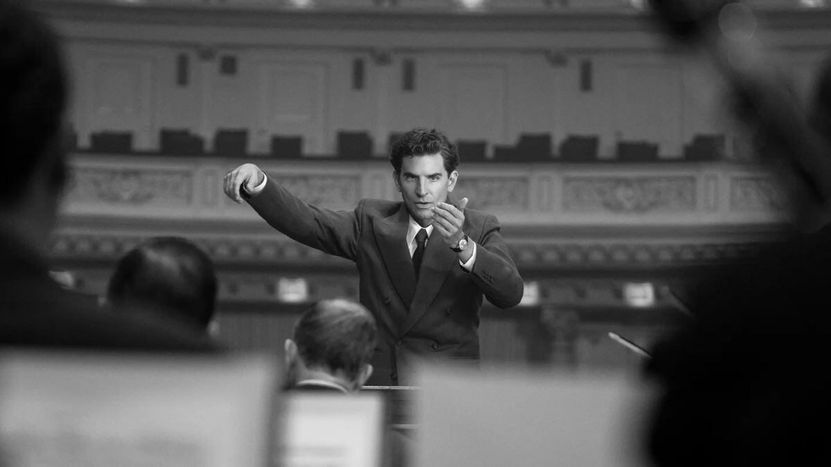 Bradley Cooper dirigiendo una orquesta en una escena de "Maestro".