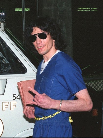 Mandatory Credit: Photo by Zuma/Shutterstock (2486229a)
Serial killer Richard Ramirez known as 'The Night Stalker' gestures to a photographer after hearing the verdict in his trial
Richard Ramirez after hearing the verdict in his trial, Los Angeles, America - 20 Sep 1989
Richard Ramirez was convicted of 13 sex slayings in the mid-1980s and was known as the Nightstalker.