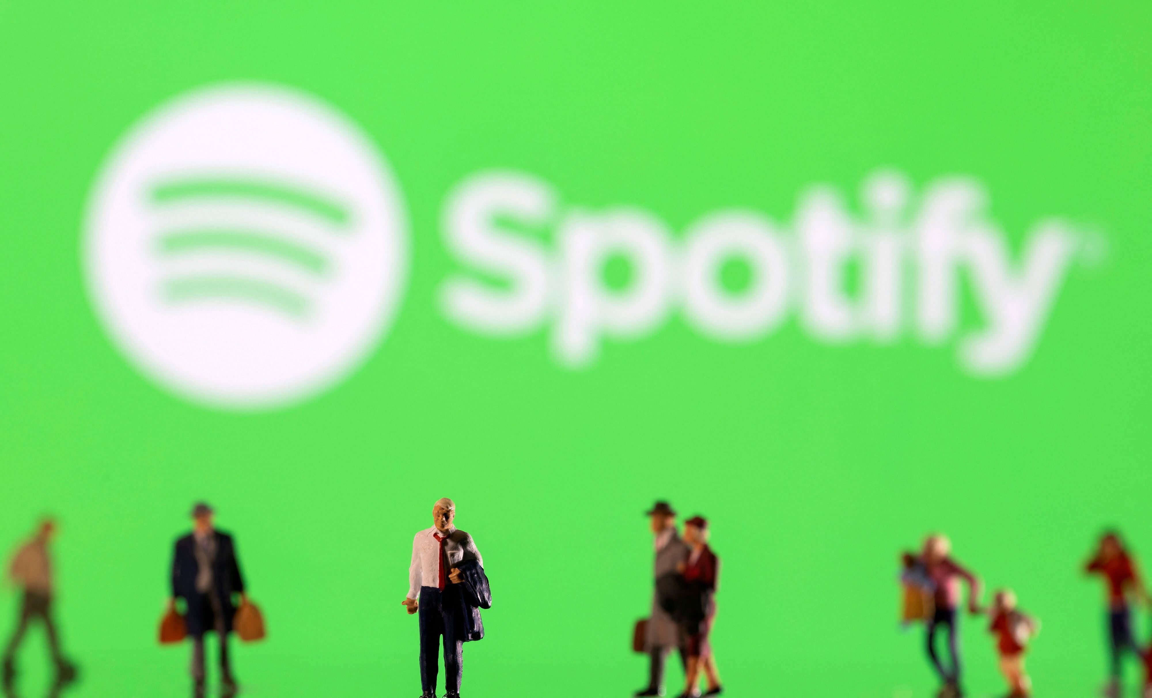 FILE PHOTO: Small figurines are seen in front of displayed Spotify logo in this illustration taken February 11, 2022. REUTERS/Dado Ruvic/Ilustration/File Photo