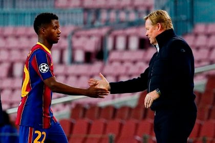 El delantero del FC Barcelona, Ansu Fati junto a al entrenador Ronald Koeman (EFE/ Enric Fontcuberta/Archivo)
