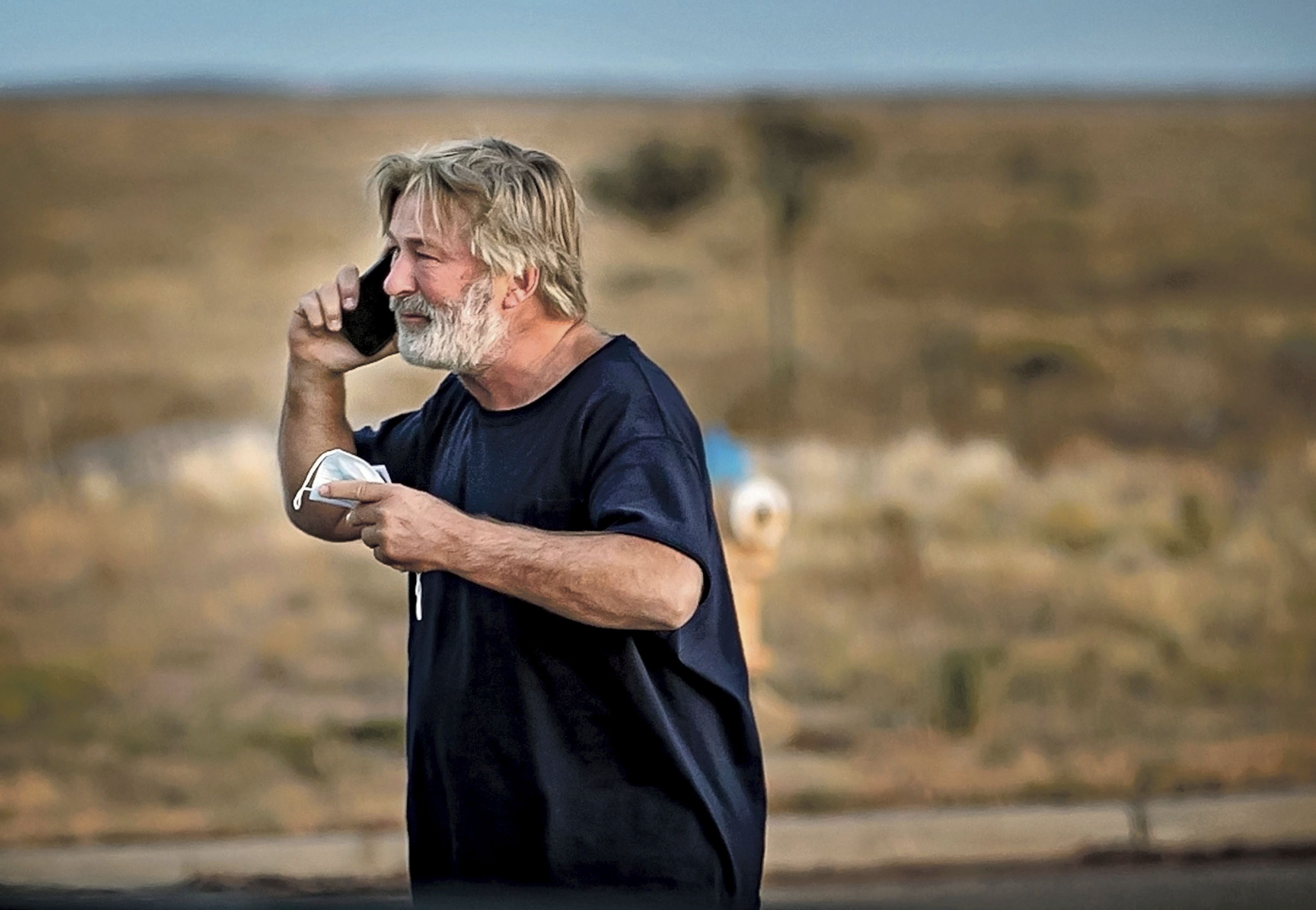 Alec Baldwin speaks on the phone in the parking lot outside the Santa Fe County Sheriff's Office in Santa Fe, N.M., after he was questioned about a shooting on the set of the film "Rust" on the outskirts of Santa Fe, Thursday, Oct. 21, 2021. Baldwin fired a prop gun on the set, killing cinematographer Halyna Hutchins and wounding director Joel Souza, officials said. (Jim Weber/Santa Fe New Mexican via AP)