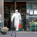A man wearing protective suit and face mask leaves a supermarket after shopping in Nice, as a lockdown is imposed to slow the rate of the coronavirus disease (COVID-19) in France, April 14, 2020. REUTERS/Eric Gaillard