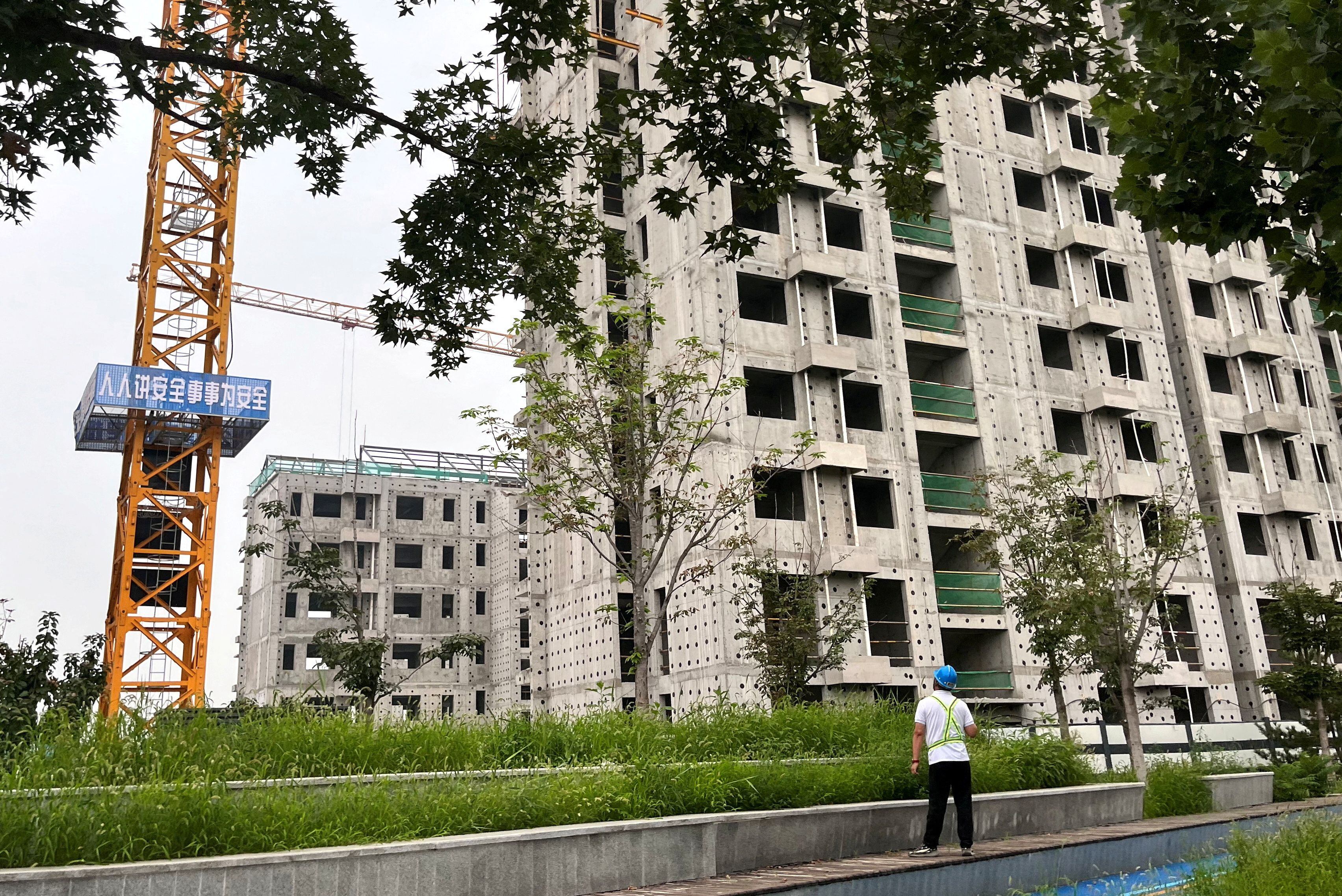 FILE PHOTO: A worker looks on at a construction site of residential buildings by Chinese developer Country Garden, in Beijing, China August 11, 2023. REUTERS/Tingshu Wang/File Photo