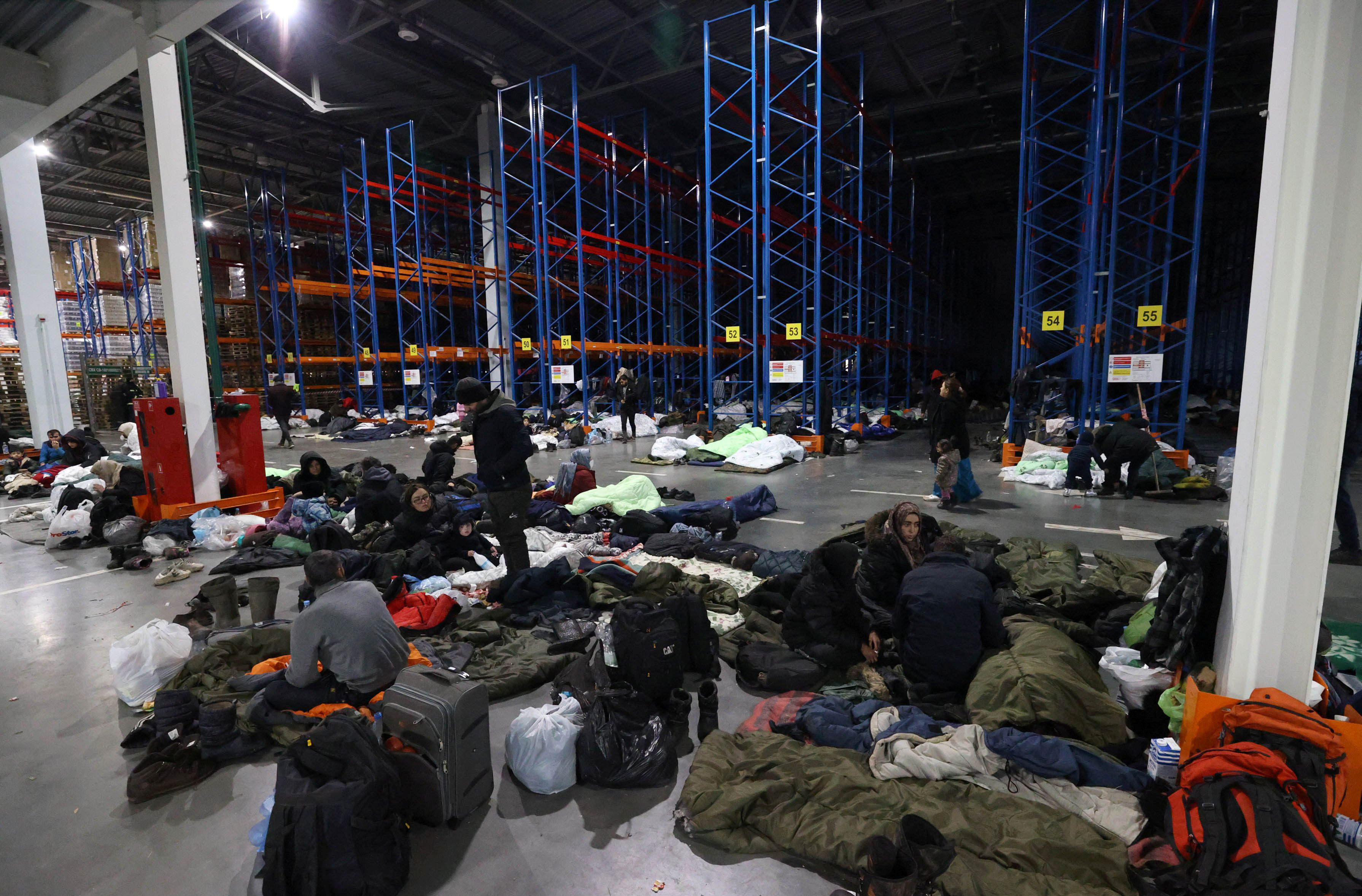 Migrants remain at the Bruzgi transport and logistics center on the Belarusian-Polish border in the Grodno region, Belarus, on November 18, 2021. (Maxim Guchek / BelTA / REUTERS)