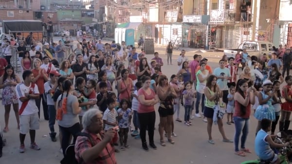 Imagen del documental: público para el primer desfile de Fuentes en el asentamiento.