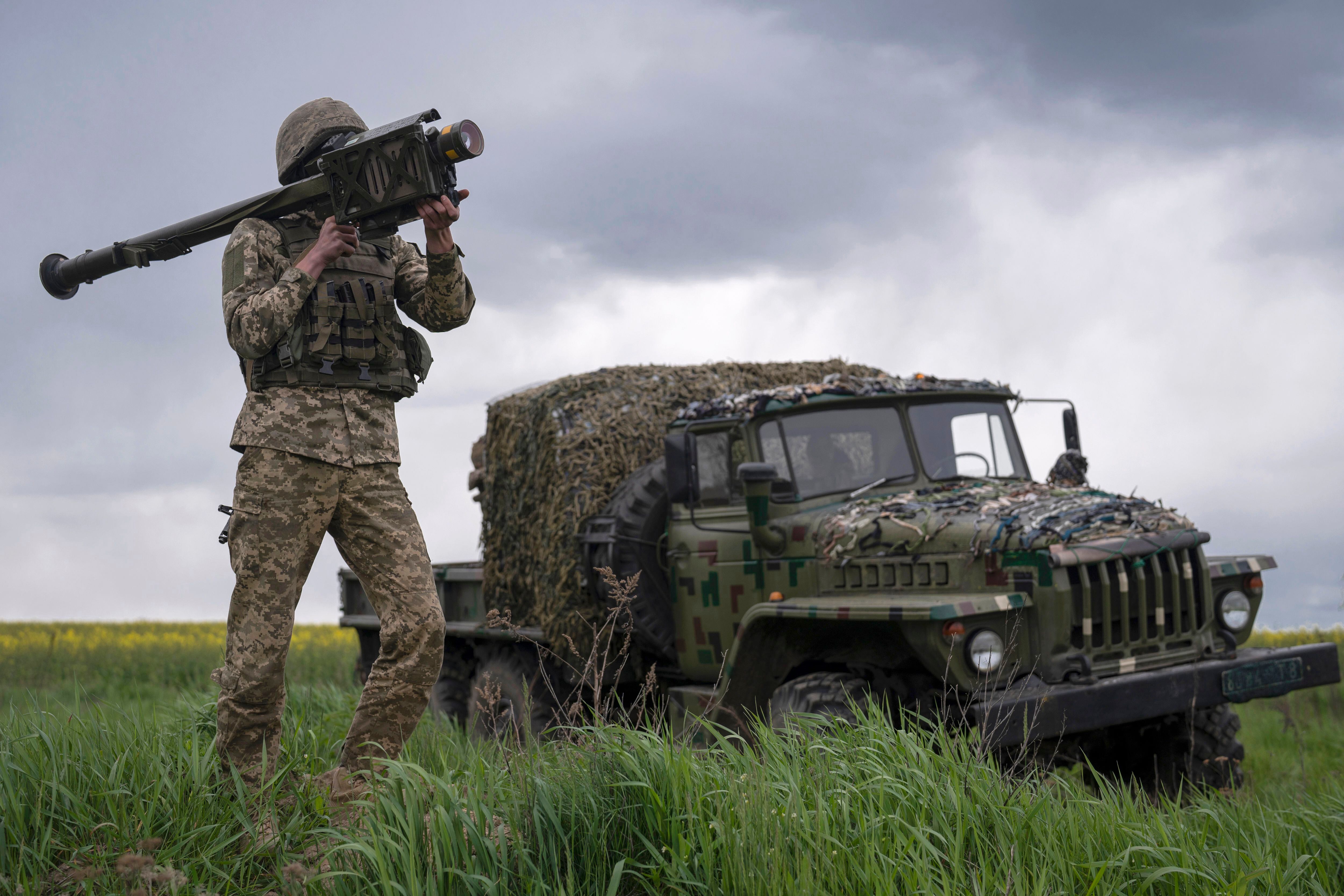 Members of a Ukrainian air-defense unit demonstrate their work near Kyiv on Monday, May 8, 2023. From camouflaged positions, the units dart out by truck into the farm fields around the capital, ready to take down enemy drones or missiles. Since Russia resumed regular air attacks on April 28, the units have a perfect score, intercepting every drone and missile shot at the capital. (AP Photo/Andrew Kravchenko)