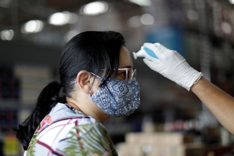 Empleados de supermercados controlan la temperatura de personas que ingresan durante el brote de coronavirus en Brasil (foto REUTERS/Ueslei Marcelino)