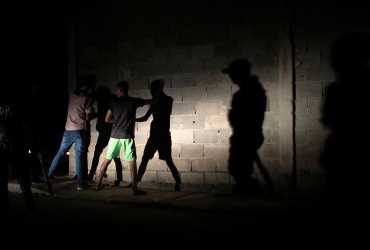 Miembros de la FAES deteniendo gente durante una patrulla nocturna en Barquisimeto (REUTERS/Ivan Alvarado)