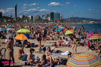 Gente disfrutando del clima cálido en la playa de Barcelona, España, el sábado 13 de junio de 2020. En la mayoría del territorio español, todavía no se permite el ingreso de turistas (AP Foto/Emilio Morenatti)