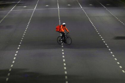 FILE PHOTO: A man who works for the mobile delivery app Rappi rides his bike on the street in Buenos Aires, Argentina April 10, 2020 REUTERS/Matias Baglietto/File Photo