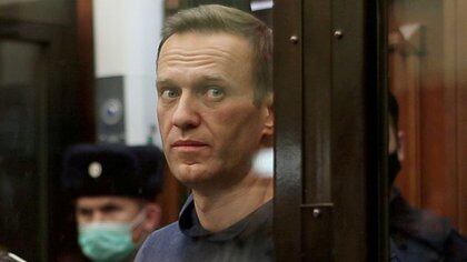 FILE PHOTO: A still image taken from video footage shows Russian opposition leader Alexei Navalny, who is accused of flouting the terms of a suspended sentence for embezzlement, inside a defendant dock during the announcement of a court verdict in Moscow, Russia February 2, 2021. Press service of Simonovsky District Court//File Photo