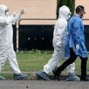 People in protective suits walk inside a sports center where Colombian citizens have been isolated after being repatriated by the Colombian government from the Chinese city of Wuhan, the epicentre of the novel coronavirus outbreak, in Bogota, Colombia February 28, 2020. REUTERS/Luisa Gonzalez