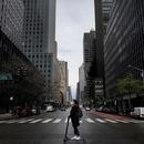 A woman wearing a protective face mask rides a scooter across a nearly empty 3rd Avenue in midtown Manhattan during the outbreak of the coronavirus disease (COVID-19) in New York City, New York, U.S., April 21, 2020. REUTERS/Mike Segar