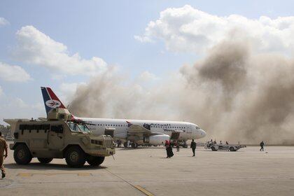 A military vehicle is seen on the tarmac as dust rises after explosions hit Aden airport, upon the arrival of the newly-formed Yemeni government in Aden, Yemen December 30, 2020. REUTERS/Fawaz Salman