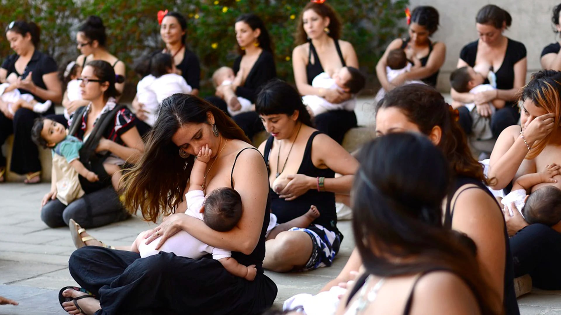 Mujeres junto a sus hijos participan de la realización de la fotografía masiva de mujeres amamantando.