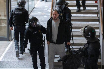 Spanish rapper Pablo Hasel reacts as he is detained by riot police inside the University of Lleida, after he was sentenced to jail time on charges including insulting the monarchy and glorifying terrorism, in Lleida, Spain February 16, 2021. REUTERS/Lorena Sopena
