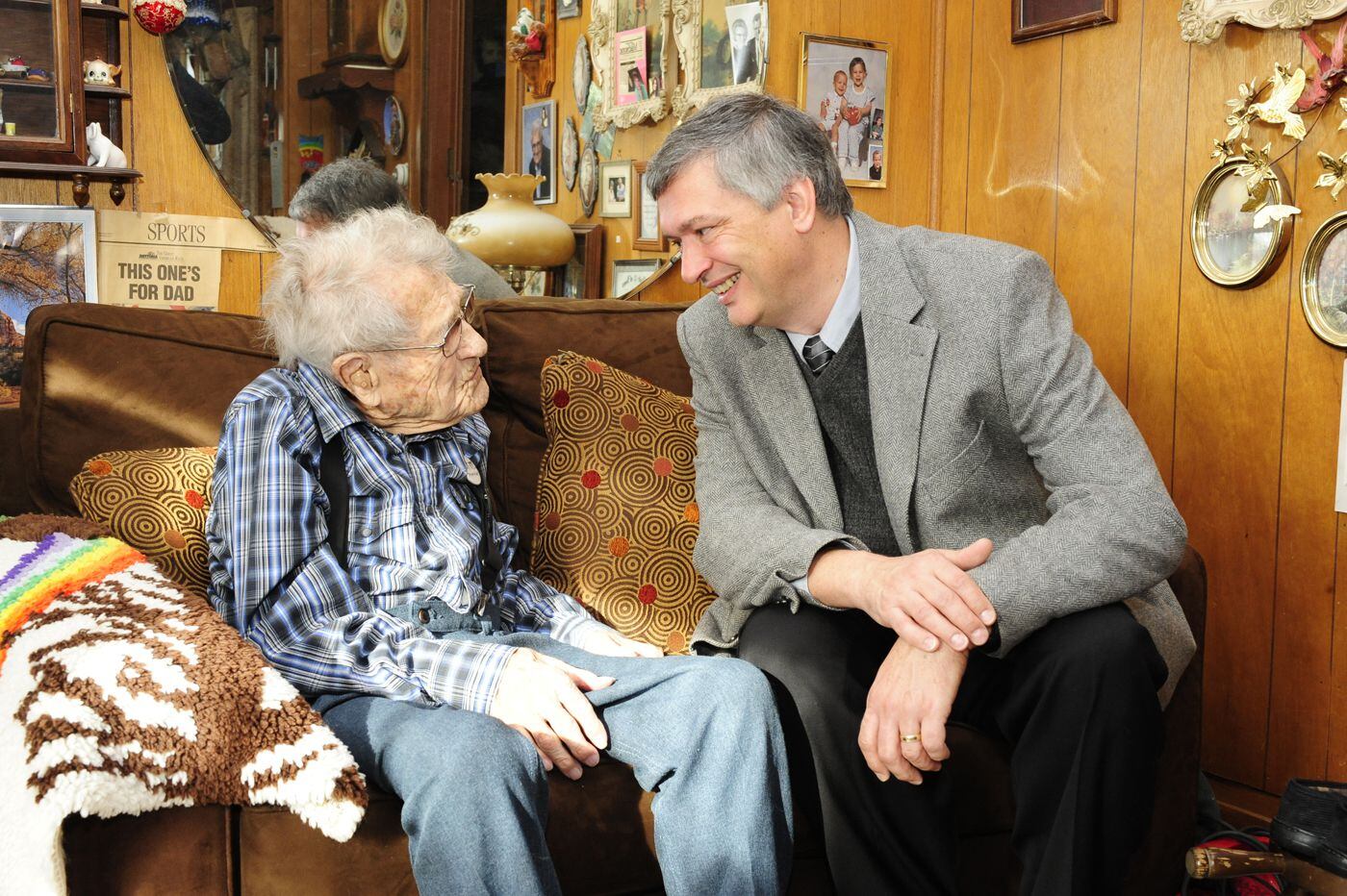 Peter Martin (right), director of Iowa State's gerontology program and a professor of human development and family studies, shares a laugh during a research session with local centenarian John Persinger.  CREDIT Photo by Bob Elbert, ISU News Service
