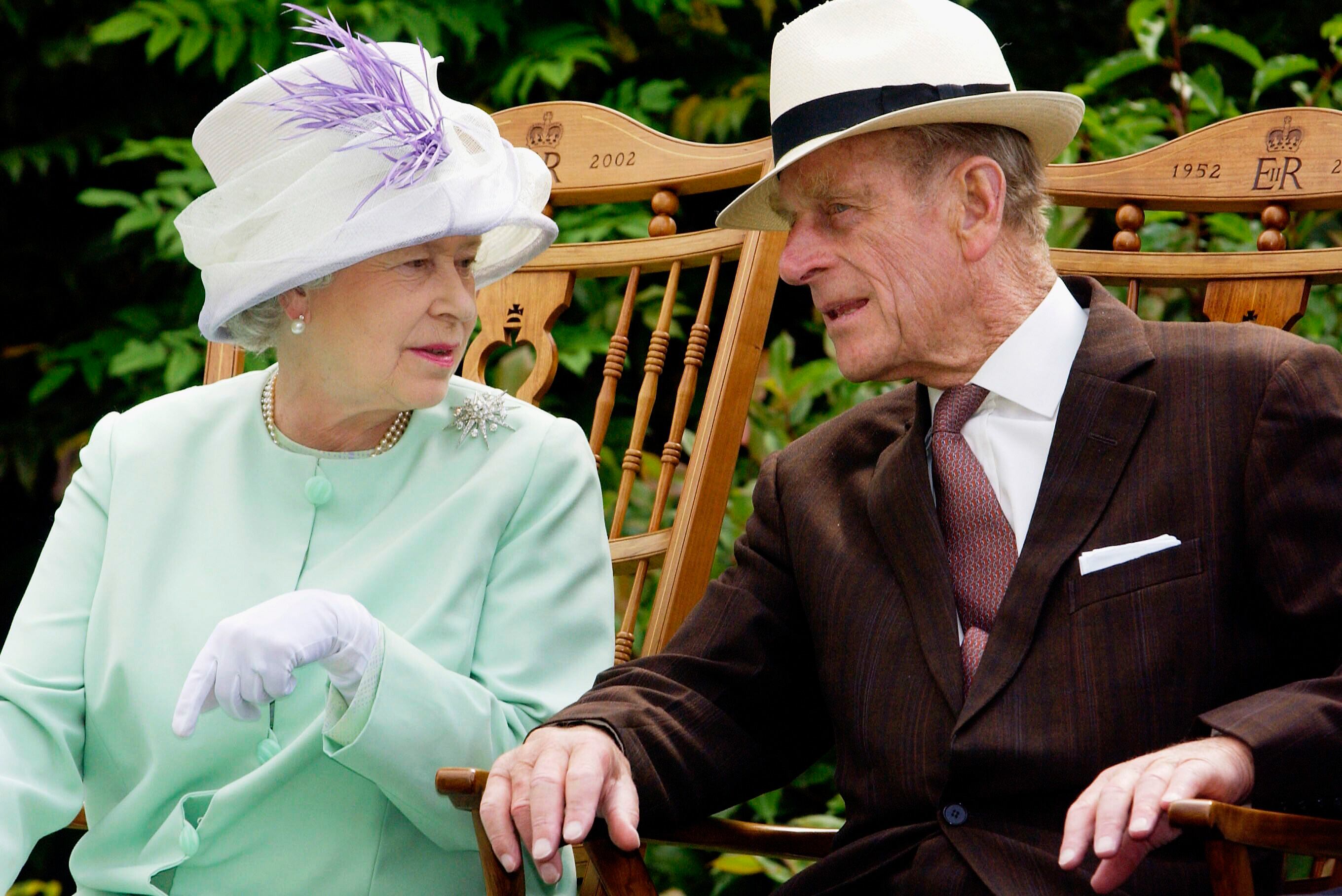 BURY ST EDMUNDS;UNITED KINGDOM - JULY 18: Queen Elizabeth II and Prince Phillip the Duke of Edinburgh chat while seated during a musical performance in the Abbey Gardens, Bury St Edmunds during her Golden Jubilee visit to Suffolk on the 18th of July 2002.(Photo by Anwar Hussein/Getty Images)