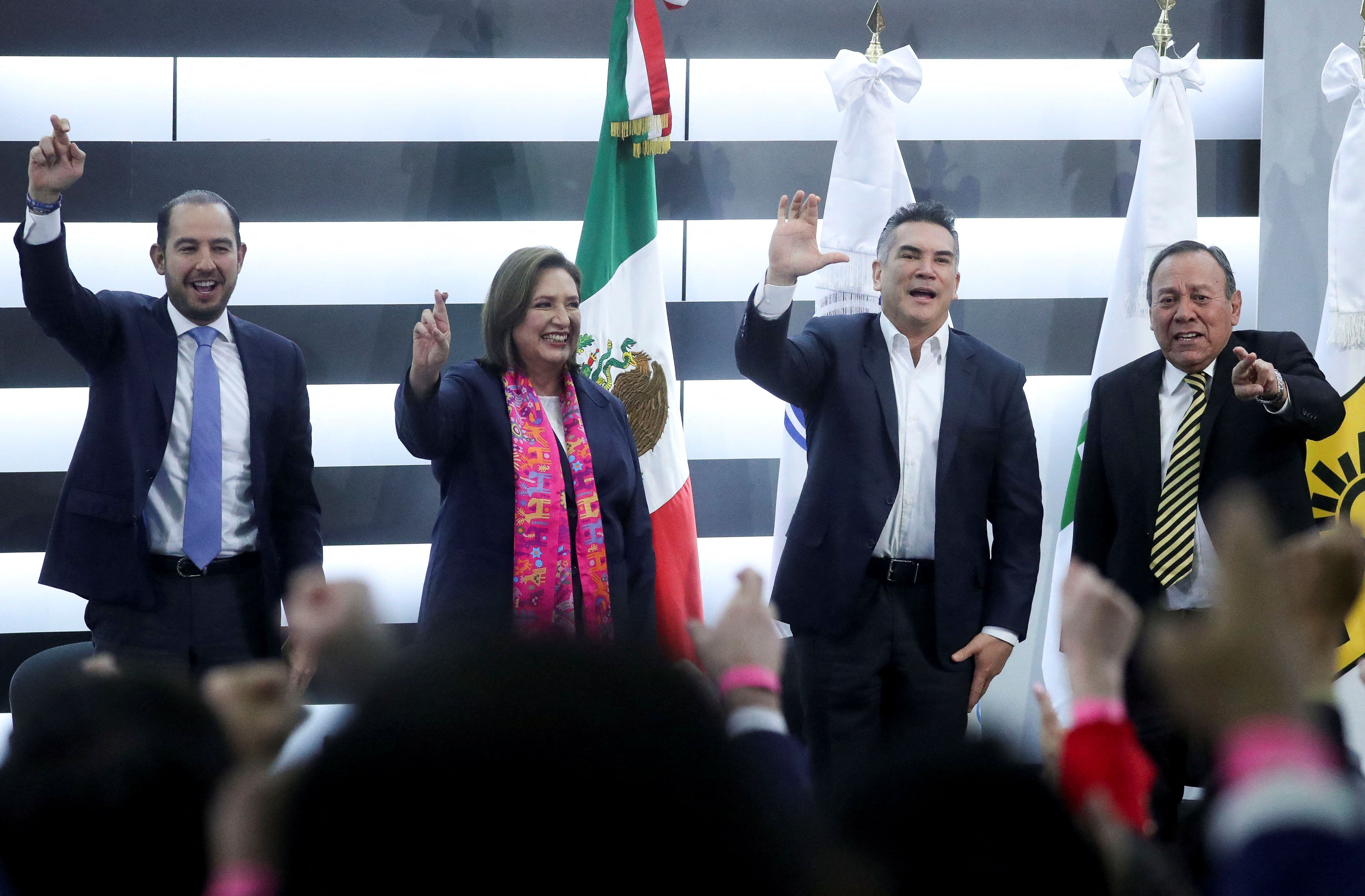 Opposition candidate Xochitl Galvez of a party coalition gestures next to President of the Institutional Revolutionary Party Alejandro Moreno, Marko Cortes, President of the National Action Party (PAN) and President of the Party of the Democratic Revolution (PRD) Jesus Zambrano, on the day of her registration as a presidential candidate for the upcoming June 2 general election at the National Electoral Institute (INE), in Mexico City, Mexico, February 20, 2024. REUTERS/Raquel Cunha