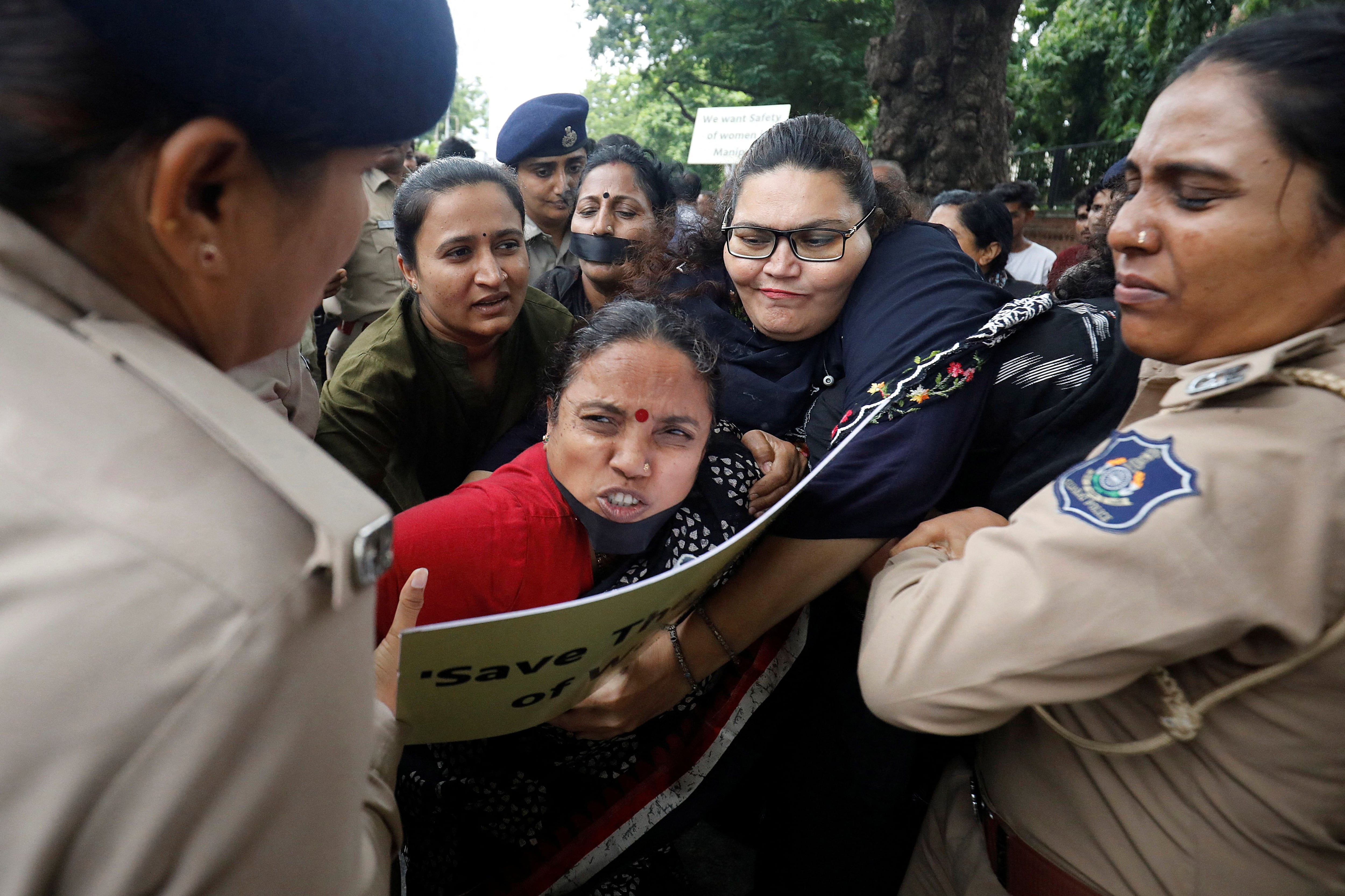 Police officers detain demonstrators during a protest against the alleged sexual assault of two tribal women in the eastern state of Manipur, in Ahmedabad, India, July 23, 2023. REUTERS/Amit Dave