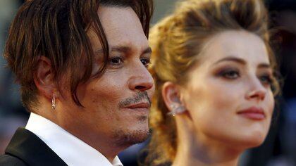 FILE PHOTO: Actress Amber Heard and her husband Johnny Depp attend the red carpet event for the movie "The Danish Girl" at the 72nd Venice Film Festival, northern Italy September 5, 2015. REUTERS/Stefano Rellandini/File Photo