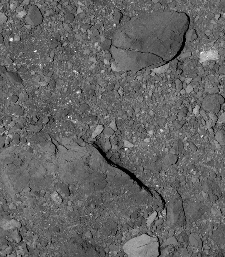Esta imagen de DS:BBD Flyby 1 muestra la superficie rocosa de Bennu justo al sur del ecuador. La roca agrietada tiene 21 metros de largo, aproximadamente la longitud de 4 lugares de estacionamiento. (Twitter: OSIRISREx)