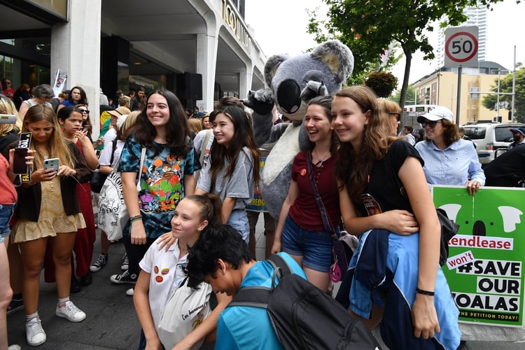 Students gather during a rally calling for action on climate change in front of the Liberal Party headquarters in Sydney on November 29, 2019. - Protesters in smoke-covered Sydney kicked off a fresh round of global protests against climate change on November 29, with activists and school kids picketing the headquarters of bushfire-ravaged Australia's ruling party. (Photo by Saeed KHAN / AFP)
