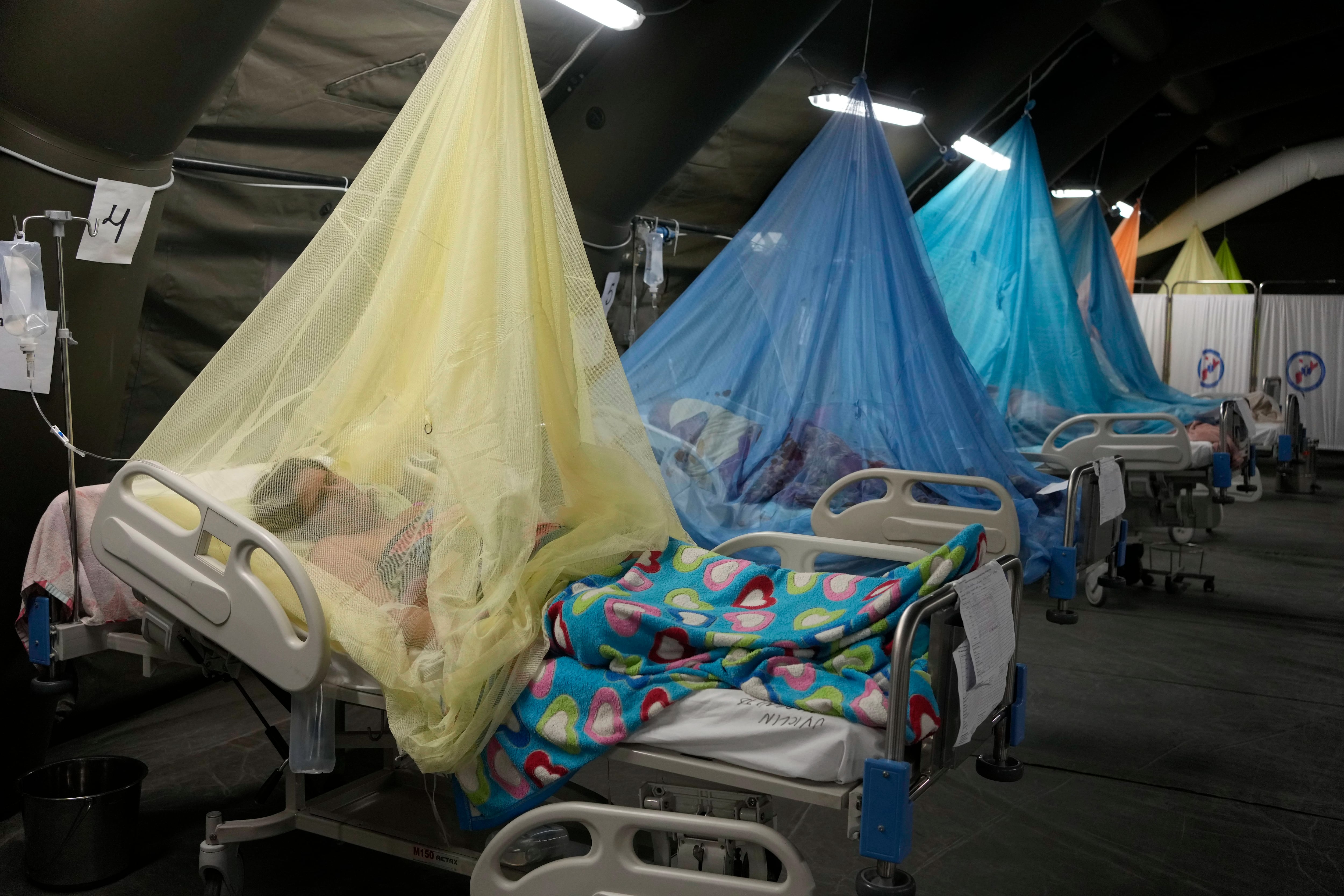 Los pacientes que padecen dengue yacen en camas ubicadas en tiendas de campaña provisionales en el Ministerio de Salud en Piura, Perú, el sábado 3 de junio de 2023. (AP Foto/Martín Mejía)